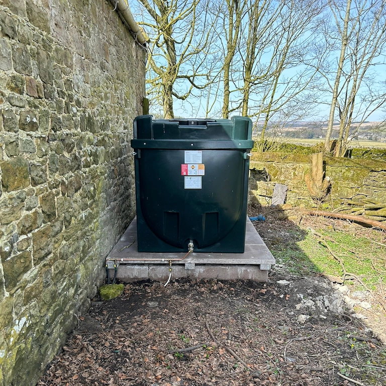Border Tank Services engineer replacing a domestic oil tank