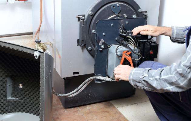 technician working servicing an oil boiler