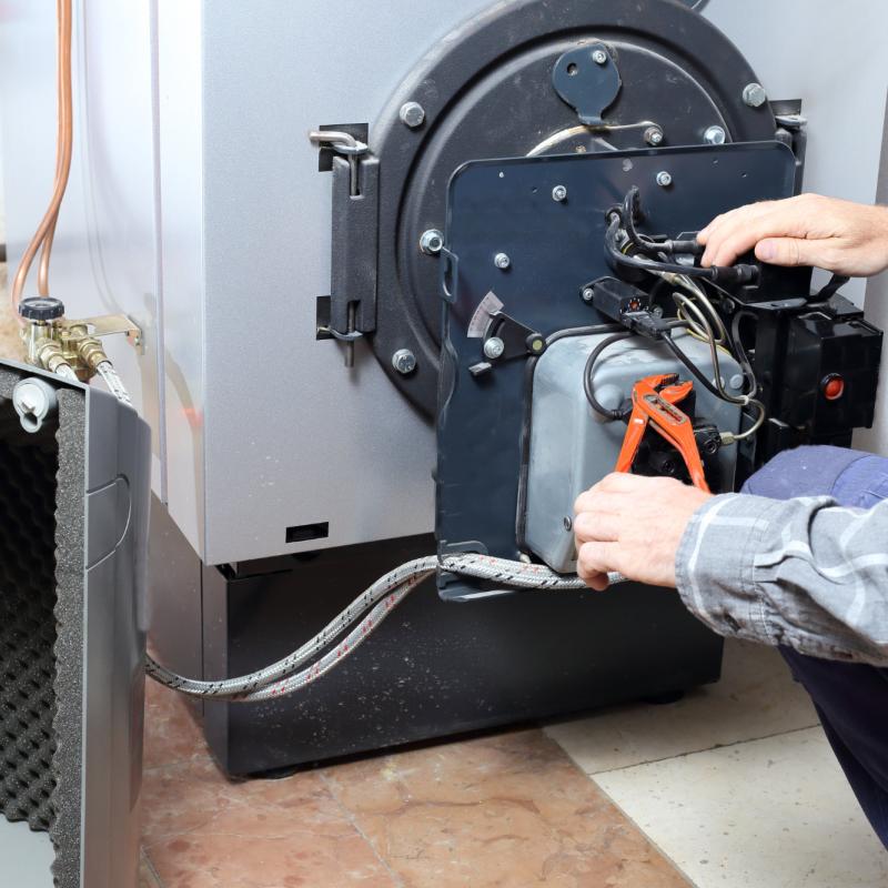 technician working servicing an oil boiler